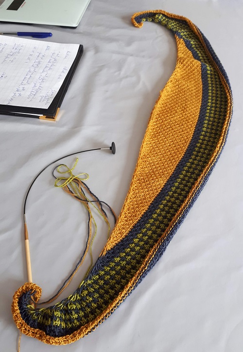 Wip Tunisian crochet crescent shawl with Triskelion yarn