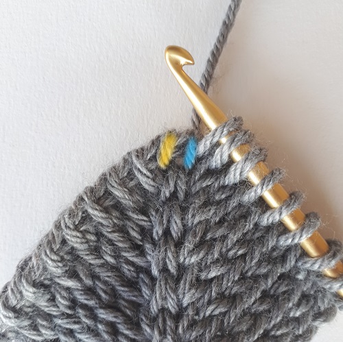Double increase - start with a Tunisian knit stitch in first stitch