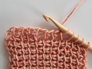 Simple method: yarn over, pull through 2. You ignore the gap.