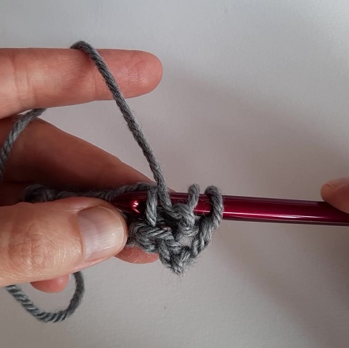 With yarn in front, insert your hook under the front vertical bar to make a Tss